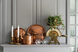 Copper items and kitchen scales on grey shelf