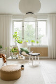 Classic chair, coffee table and pouffe in bright living room