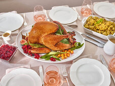 Set table with roast turkey and side dishes