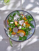 Rocket salad with peach, radish and feta