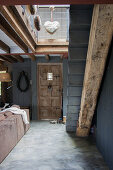 Rustic open-plan interior with metal stairs on wooden beam