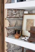 Shelving panelled with rustic logs