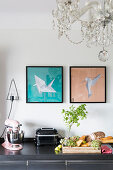 Pictures of origami birds and chandelier in kitchen