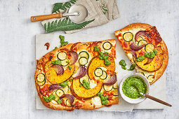 Pumpkin and zucchini pizza with basil dressing