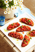 Bruschetta with tomato, basil and capers