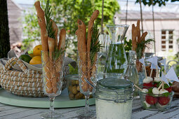Small buffet: champagne flutes with bread sticks and rosemary, mozzarella tomato skewers, olives, quark and herb dip