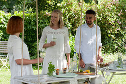 Friends at the hanging table made of a white painted pallet