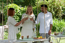 Hanging table made of a pallet painted white, friends toast