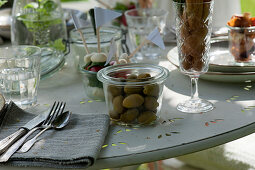 Set table: detail of glass with olives