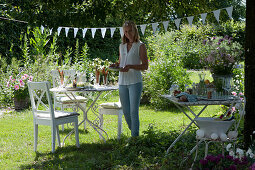 Woman sets the table in the garden