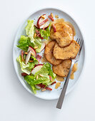 Chicken escalope in a white wine sauce with an apple salad