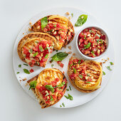 Bruschetta with grilled cheese and a tomato and almond salsa