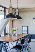 Industrial lamps above dining table in loft apartment