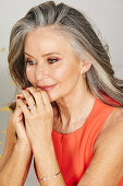 A grey-haired woman wearing subtle make-up