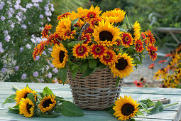 Lush bouquet of sunflowers and zinnias in a basket