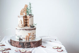 A two-tier baked apple cake with cinnamon buttercream and Christmas decorations