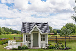 A Scandinavian style playhouse in a garden