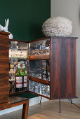 A sideboard as a bar cabinet with lighting and glass shelves