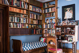 Framed artwork and desk with book-shelving in study