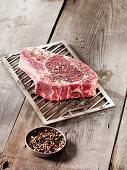 A raw steak on a Beefer grilling rack