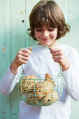 Boy with basket of hedgehog rolls