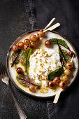 Grilled grapes with burrata, fennel seeds, olive oil and beet leaves