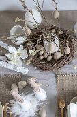 Artistically twisted candles on table set for Easter meal