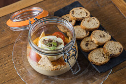 Chickpea hummus with truffle arranged with raisin bread on wooden table in restaurant