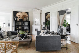 Sofa set, coffee table, glass cabinet and tiled stove in the living room