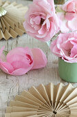 Romantic arrangement of roses and brown paper rosettes