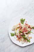 Cauliflower salad with chickpeas, pomegranate seeds and nuts