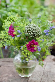 Bouquet of cosmea, lady's mantel, viper's bugloss, allium and poppy seed heads