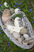 Eggs covered in various materials in basket