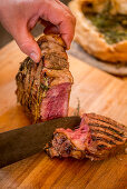 Porterhouse steak grilled in a salt crust, sliced