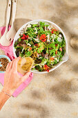 A colourful garden salad with marinated feta and nasturtiums