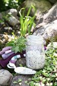 Bath salt with herbs in a clip-on glass jar