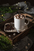 Hot drink with marshmallow with Christmas lights