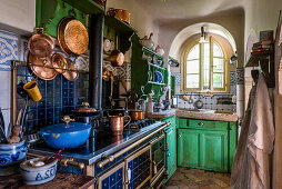 Rustic kitchen with hanging copper pans