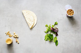 Snack ingredients – tortillas, mixed leaf salad, creamy peanut butter and fried onions
