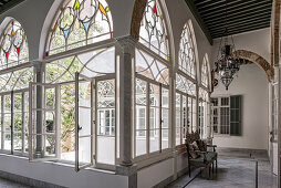 Arched, stained-glass windows overlooking courtyard of Oriental palace