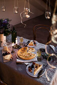 Sauerkraut quiche with apples on a festively laid table for two