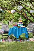 Colorful table with diaper cake and garlands for a baby shower party