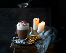 Hot chocolate with frothy milk and cocoa powder