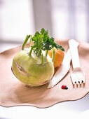 Kohlrabi on a wooden plate with wooden cutlery