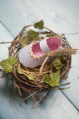 Homemade paper baby shoes in nests as place cards