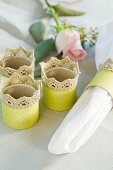 Homemade napkin rings with lace border and yellow paper
