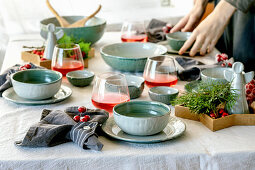 Rustic Christmas table setting with craft ceramic tableware, plates and bowls