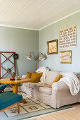 Living room with pale green walls decorated with flea-market finds