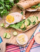 Sandwich with hummus, vegetables and a fried egg
