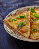 Three cheese pizza with basil